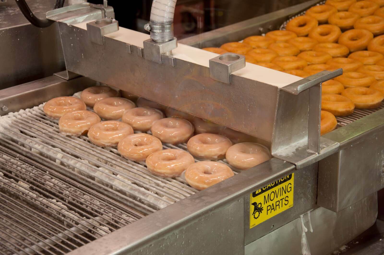 donuts-factory-machine-glazing-of-fresh-made-donu-2023-11-27-05-30-07-utc